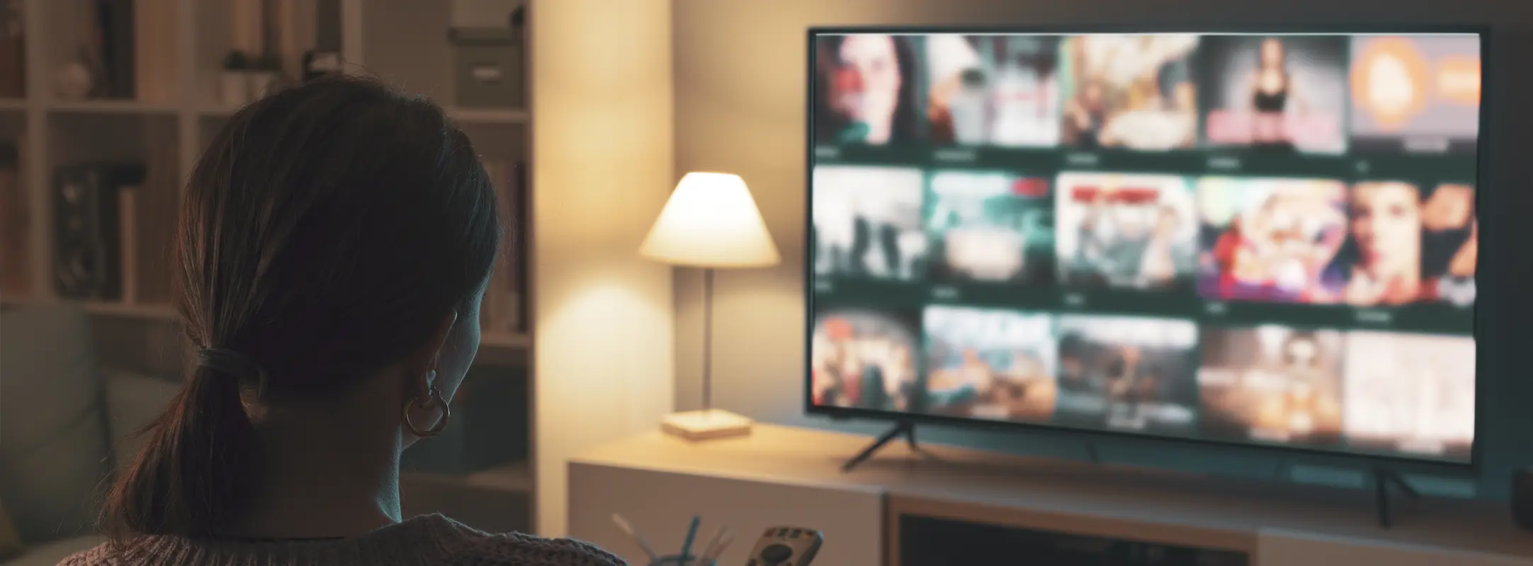 Vrouw op de bank kijkend naar een online streamingdienst, een van de populairste abonnementen van Nederland